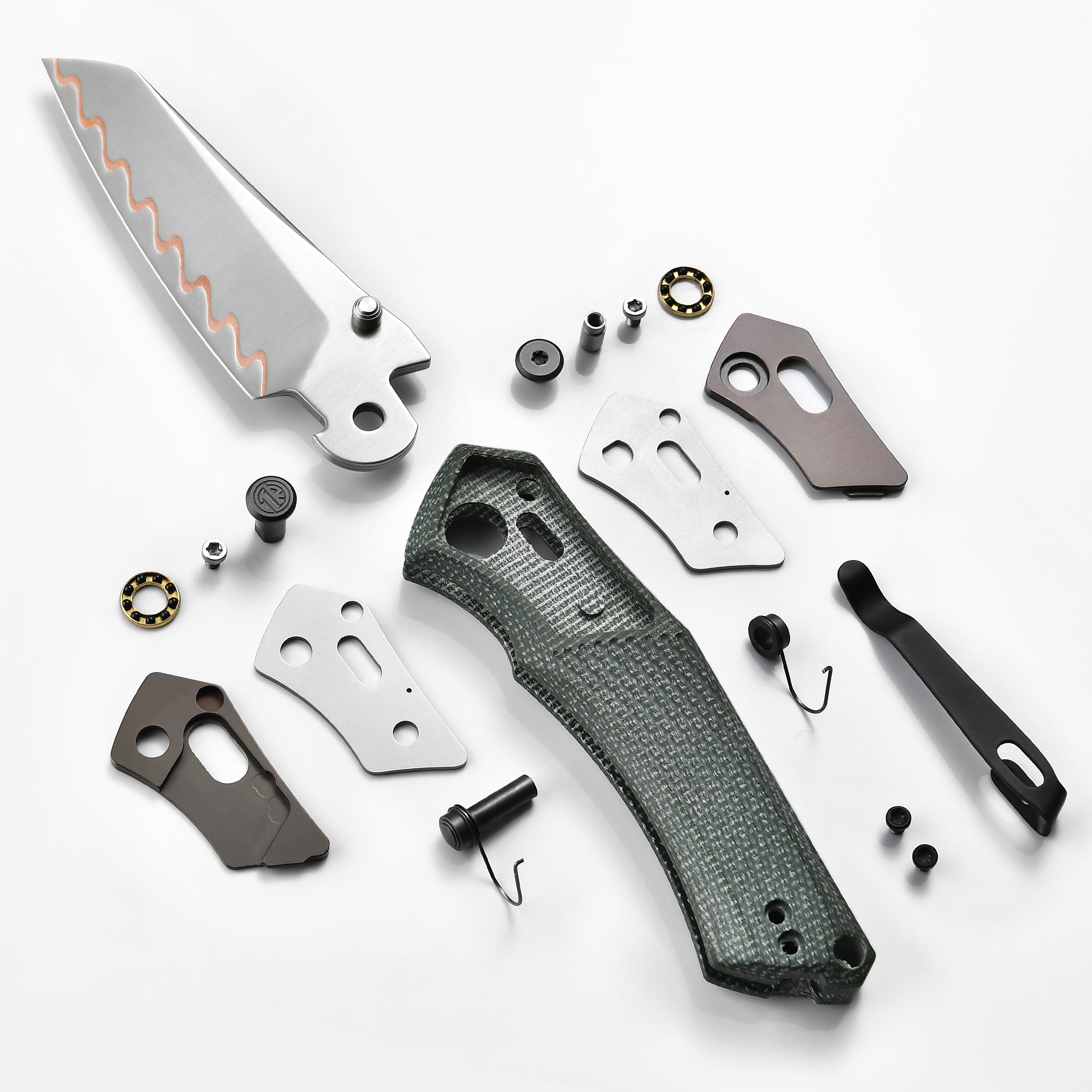 Disassembled Tacray Talos knife with its components on a white background