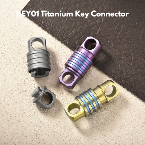 Tacray titanium key connectors in gray, purple, and gold on a textured surface.